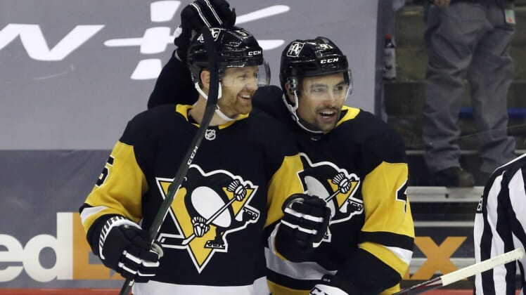 Apr 20, 2021; Pittsburgh, Pennsylvania, USA;  Pittsburgh Penguins defenseman Mike Matheson (5) celebrates with defenseman Cody Ceci (4) after scoring a goal against the New Jersey Devils during the first period at PPG Paints Arena. Mandatory Credit: Charles LeClaire-USA TODAY Sports