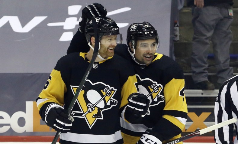 Apr 20, 2021; Pittsburgh, Pennsylvania, USA;  Pittsburgh Penguins defenseman Mike Matheson (5) celebrates with defenseman Cody Ceci (4) after scoring a goal against the New Jersey Devils during the first period at PPG Paints Arena. Mandatory Credit: Charles LeClaire-USA TODAY Sports