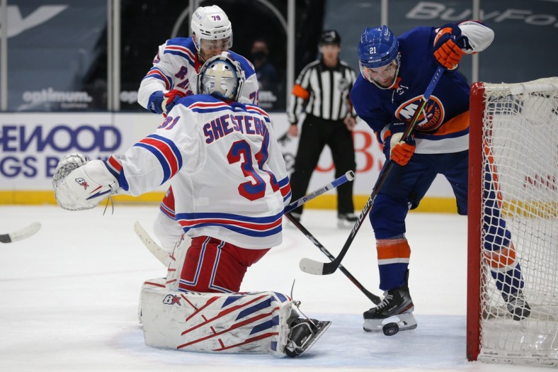 Apr 20, 2021; Uniondale, New York, USA; New York Islanders right wing Kyle Palmieri (21) plays the puck against New York Rangers goalie Igor Shesterkin (31) and defenseman K'Andre Miller (79) during the first period at Nassau Veterans Memorial Coliseum. Mandatory Credit: Brad Penner-USA TODAY Sports