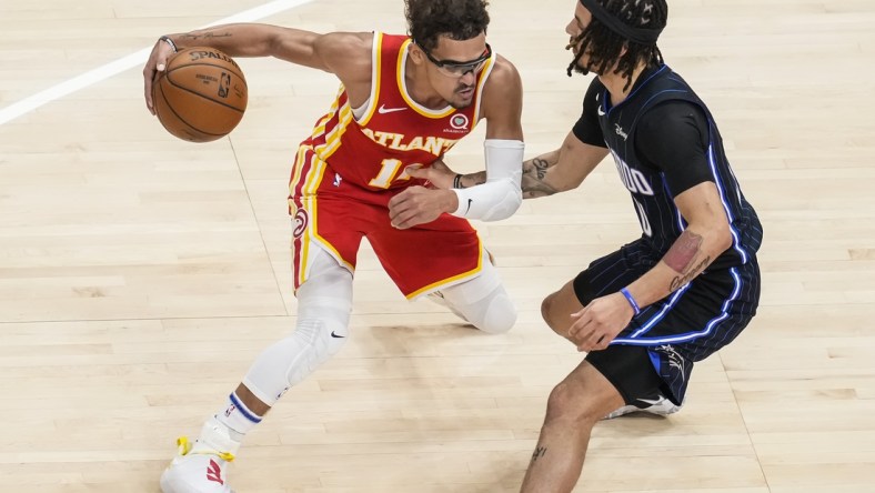 Apr 20, 2021; Atlanta, Georgia, USA; Atlanta Hawks guard Trae Young (11) dribbles against Orlando Magic guard Cole Anthony (50) during the first quarter at State Farm Arena. Mandatory Credit: Dale Zanine-USA TODAY Sports