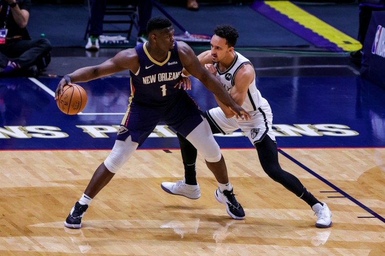 Apr 20, 2021; New Orleans, Louisiana, USA; New Orleans Pelicans forward Zion Williamson (1) looks to pass the ball against Brooklyn Nets guard Landry Shamet (20) during the first half at the Smoothie King Center. Mandatory Credit: Stephen Lew-USA TODAY Sports