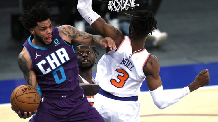 Apr 20, 2021; New York, New York, USA;  Miles Bridges #0 of the Charlotte Hornets looks to pass as Julius Randle #30 and Nerlens Noel #3 of the New York Knicks defend during the first half at Madison Square Garden. Mandatory Credit:  Sarah Stier/POOL PHOTOS-USA TODAY Sports