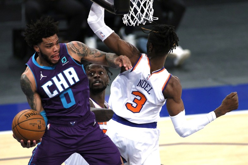 Apr 20, 2021; New York, New York, USA;  Miles Bridges #0 of the Charlotte Hornets looks to pass as Julius Randle #30 and Nerlens Noel #3 of the New York Knicks defend during the first half at Madison Square Garden. Mandatory Credit:  Sarah Stier/POOL PHOTOS-USA TODAY Sports