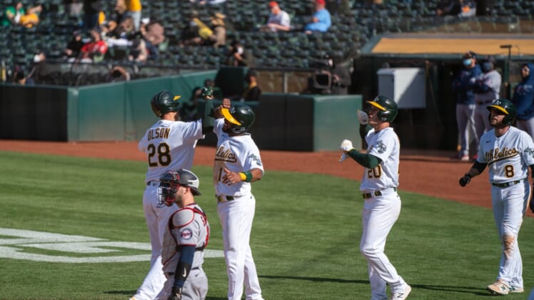 Apr 20, 2021; Oakland, California, USA;  Oakland Athletics first baseman Matt Olson (28) celebrates after hitting a grand slam home run with Oakland Athletics shortstop Elvis Andrus (17) and teammates during the fourth inning |T at RingCentral Coliseum. Mandatory Credit: Neville E. Guard-USA TODAY Sports