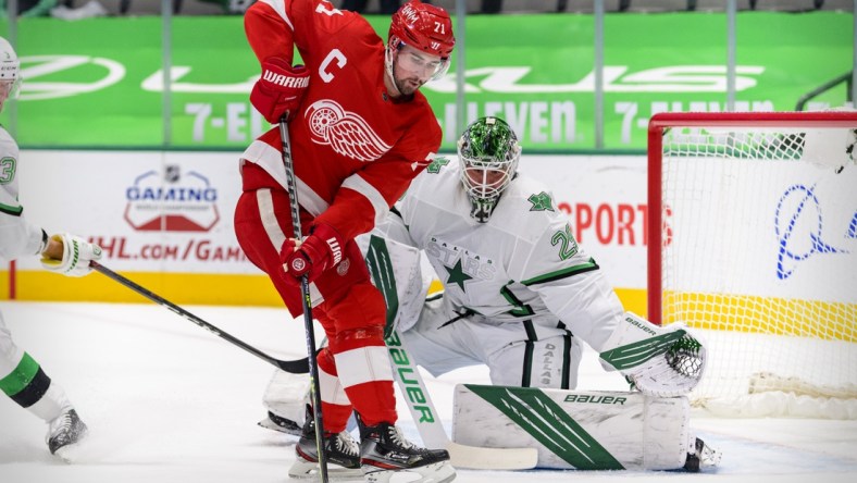 Apr 20, 2021; Dallas, Texas, USA; Dallas Stars goaltender Jake Oettinger (29) defends against Detroit Red Wings center Dylan Larkin (71) during the first period at the American Airlines Center. Mandatory Credit: Jerome Miron-USA TODAY Sports