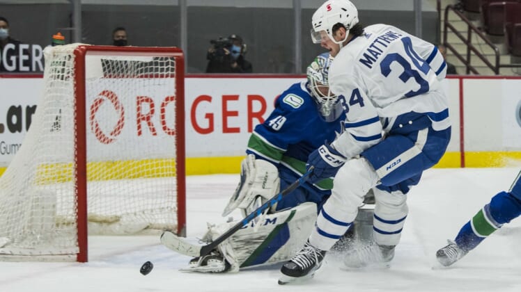 Apr 20, 2021; Vancouver, British Columbia, CAN;  Vancouver Canucks goalie Braden Holtby (49) makes a save on Toronto Maple Leafs forward Auston Matthews (34) in the first period at Rogers Arena. Mandatory Credit: Bob Frid-USA TODAY Sports