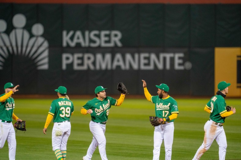 Apr 20, 2021; Oakland, California, USA; Oakland Athletics left fielder Mark Canha (20) and second baseman Vimael Machin (39) and shortstop Elvis Andrus (17) and center fielder Ramon Laureano (22) and Oakland Athletics right fielder Seth Brown (15) celebrate after the end of the game against the Minnesota Twins at RingCentral Coliseum. Mandatory Credit: Neville E. Guard-USA TODAY Sports