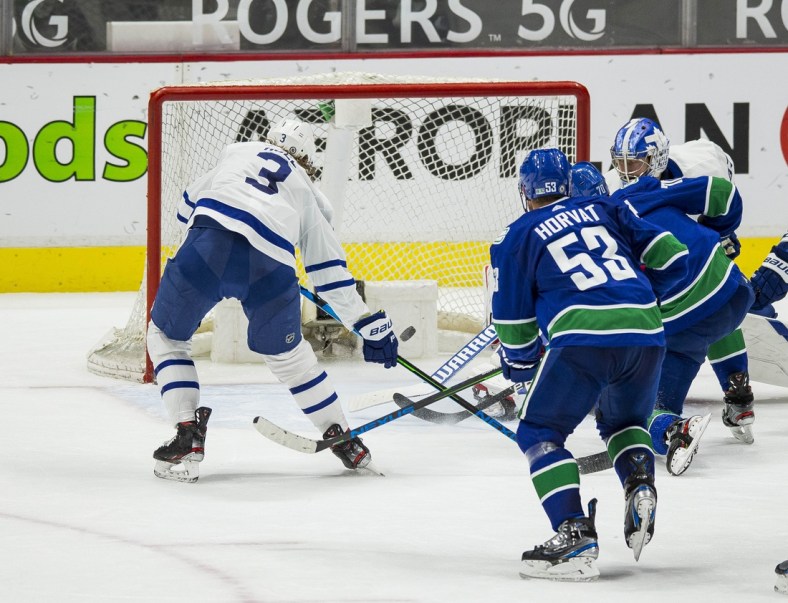 Apr 20, 2021; Vancouver, British Columbia, CAN; Vancouver Canucks forward Tanner Pearson (70) scores on Toronto Maple Leafs goalie David Rittich (33) as Maple Leafs defenseman Justin Holl (3) looks on in the third period at Rogers Arena. Canucks won 6-3. Mandatory Credit: Bob Frid-USA TODAY Sports