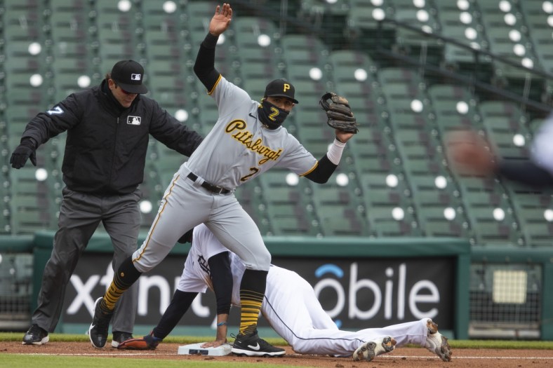 Apr 21, 2021; Detroit, Michigan, USA; Detroit Tigers right fielder Victor Reyes (22) slides safely into third base against Pittsburgh Pirates second baseman Erik Gonzalez (2) during the third inning at Comerica Park. Mandatory Credit: Raj Mehta-USA TODAY Sports