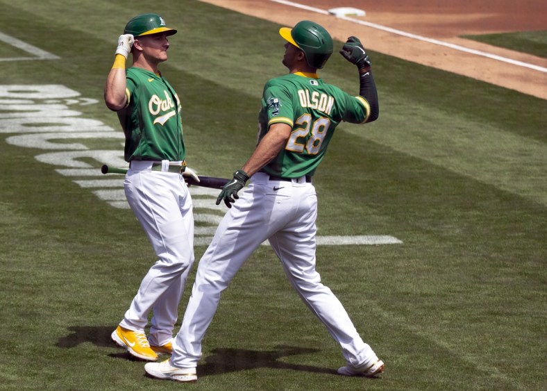 Apr 21, 2021; Oakland, California, USA; Oakland Athletics Matt Olson (28) gets an elbow bash from teammate Matt Chapman after hitting a solo home run against the Minnesota Twins during the second inning of a Major League Baseball game at RingCentral Coliseum. Mandatory Credit: D. Ross Cameron-USA TODAY Sports