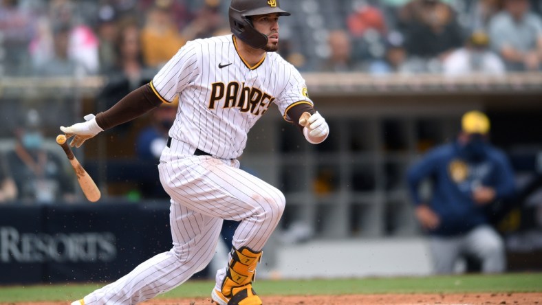 Apr 21, 2021; San Diego, California, USA; San Diego Padres catcher Victor Caratini (17) scores right fielder Jurickson Profar (not pictured) on a ground out during the fourth inning against the Milwaukee Brewers at Petco Park. Mandatory Credit: Orlando Ramirez-USA TODAY Sports