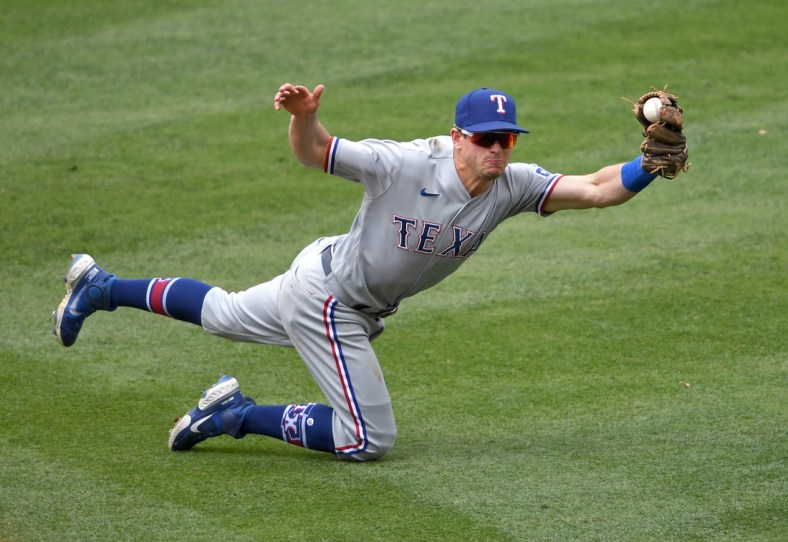 Apr 21, 2021; Anaheim, California, USA;  Texas Rangers second baseman Nick Solak (15) catches a line drive hit by Los Angeles Angels shortstop Jose Iglesias (4) for the final out of the fourth the first inning of the game at Angel Stadium. Mandatory Credit: Jayne Kamin-Oncea-USA TODAY Sports
