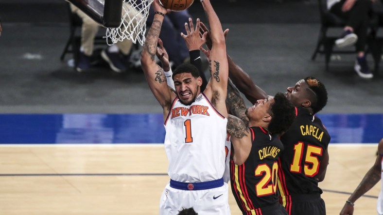 Apr 21, 2021; New York, New York, USA; New York Knicks forward Obi Toppin (1) grabs a rebound against Atlanta Hawks forward John Collins (20) and center Clint Capela (15) in the second quarter at Madison Square Garden. Mandatory Credit: Wendell Cruz-USA TODAY Sports