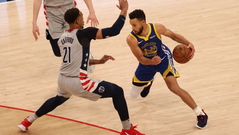 Apr 21, 2021; Washington, District of Columbia, USA; Golden State Warriors guard Stephen Curry (30) drives to the basket past Washington Wizards center Daniel Gafford (21) in the fourth quarter at Capital One Arena. Mandatory Credit: Geoff Burke-USA TODAY Sports