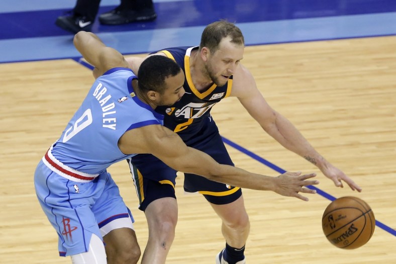 Apr 21, 2021; Houston, Texas, USA;  Houston Rockets guard Avery Bradley (9) reaches for the ball as Utah Jazz guard Joe Ingles (2) tries to drive around during the second half of an NBA basketball game at Toyota Center. Mandatory Credit:  POOL PHOTOS-USA TODAY Sports