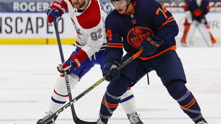 Apr 21, 2021; Edmonton, Alberta, CAN; Edmonton Oilersdefensemen Ethan Bear (74) and Montreal Canadiens forward Jonathan Drouin (92) battle for a loose puck during the first period at Rogers Place. Mandatory Credit: Perry Nelson-USA TODAY Sports