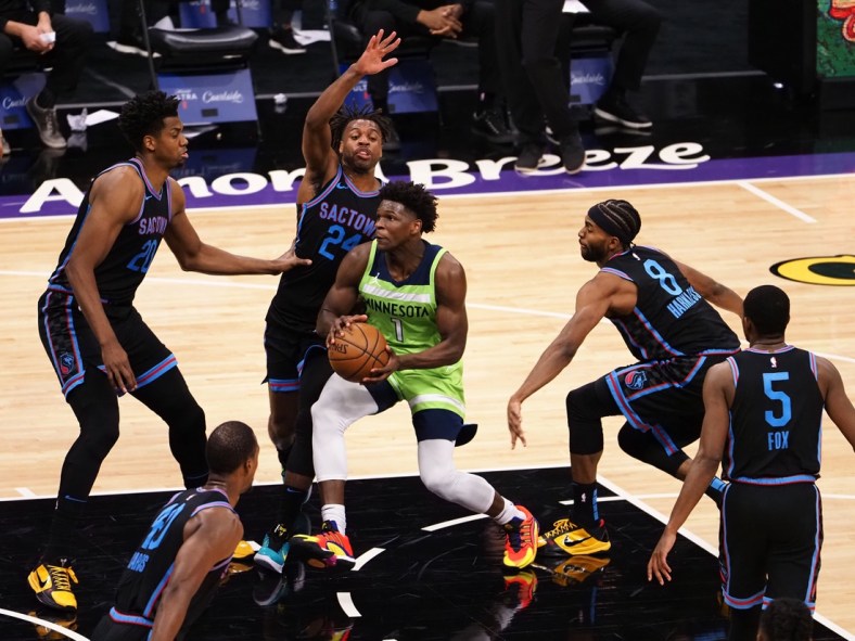 Apr 21, 2021; Sacramento, California, USA; Minnesota Timberwolves forward Anthony Edwards (1) drives in between Sacramento Kings center Hassan Whiteside (20), guard Buddy Hield (24) and forward Maurice Harkless (8) during the second quarter at Golden 1 Center. Mandatory Credit: Kelley L Cox-USA TODAY Sports