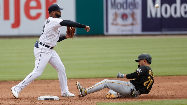 Apr 22, 2021; Detroit, Michigan, USA;  Detroit Tigers shortstop Willi Castro (9) makes a throw to first for a double play as Pittsburgh Pirates second baseman Adam Frazier (26) slides into second in the fourth inning at Comerica Park. Mandatory Credit: Rick Osentoski-USA TODAY Sports