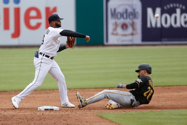 Apr 22, 2021; Detroit, Michigan, USA;  Detroit Tigers shortstop Willi Castro (9) makes a throw to first for a double play as Pittsburgh Pirates second baseman Adam Frazier (26) slides into second in the fourth inning at Comerica Park. Mandatory Credit: Rick Osentoski-USA TODAY Sports