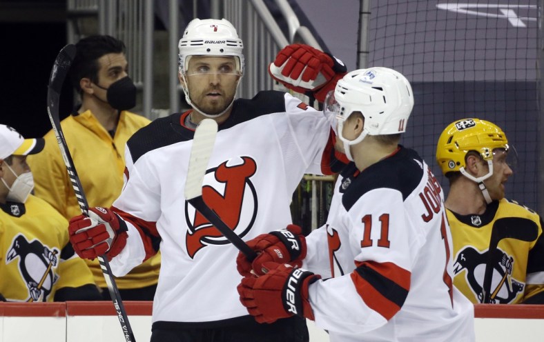 Apr 22, 2021; Pittsburgh, Pennsylvania, USA;  New Jersey Devils defenseman Matt Tennyson (7) celebrates with left wing Andreas Johnsson (11) after scoring a goal against the Pittsburgh Penguins during the first period at PPG Paints Arena. Mandatory Credit: Charles LeClaire-USA TODAY Sports
