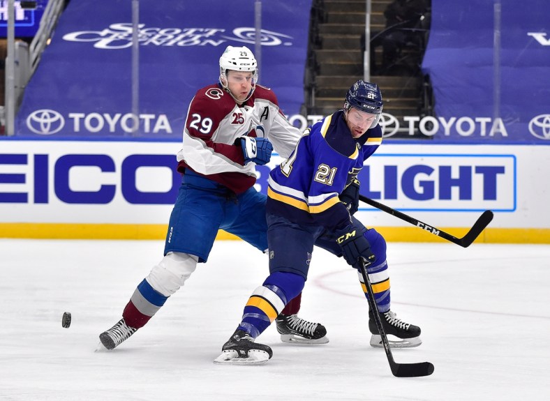 Apr 22, 2021; St. Louis, Missouri, USA;  Colorado Avalanche center Nathan MacKinnon (29) defends against St. Louis Blues center Tyler Bozak (21) during the first period at Enterprise Center. Mandatory Credit: Jeff Curry-USA TODAY Sports
