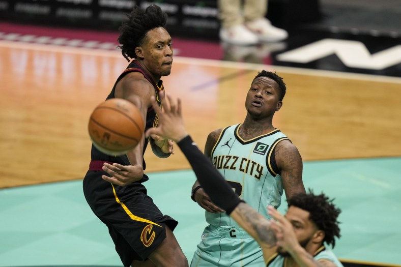 Apr 23, 2021; Charlotte, North Carolina, USA; Cleveland Cavaliers guard Collin Sexton (L) passes the ball in front of Charlotte Hornets guard Terry Rozier (C) during the first quarter at the Spectrum Center. Mandatory Credit: Jim Dedmon-USA TODAY Sports