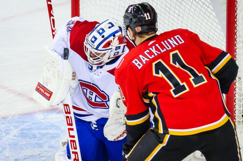 Apr 23, 2021; Calgary, Alberta, CAN; Montreal Canadiens goaltender Jake Allen (34) makes a save against the Calgary Flames during the second period at Scotiabank Saddledome. Mandatory Credit: Sergei Belski-USA TODAY Sports