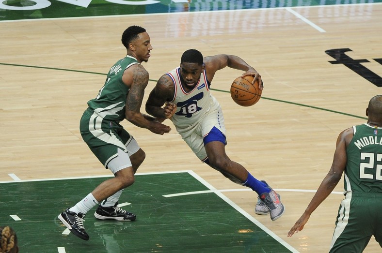 Apr 24, 2021; Milwaukee, Wisconsin, USA;  Philadelphia 76ers guard Shake Milton (18) drives to the basket against Milwaukee Bucks guard Jeff Teague (5) in the second quarter at Fiserv Forum. Mandatory Credit: Michael McLoone-USA TODAY Sports