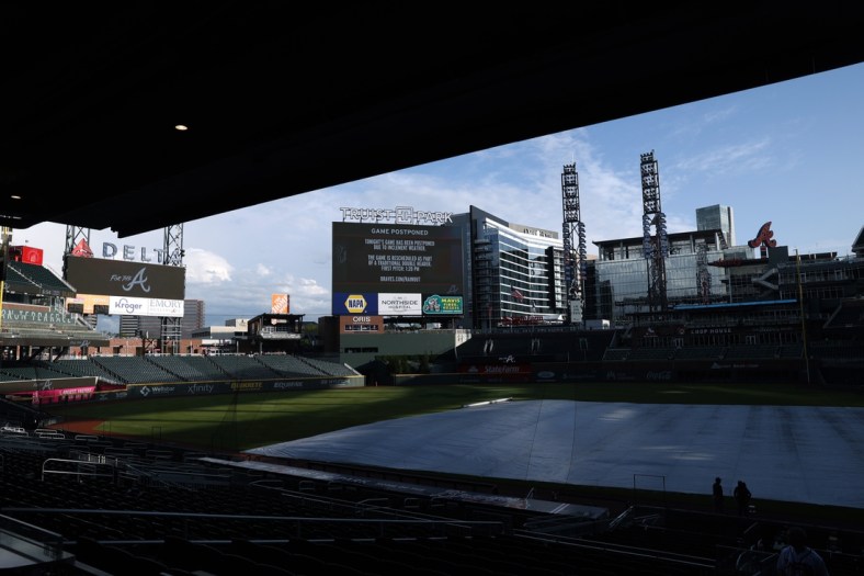 Apr 24, 2021; Atlanta, Georgia, USA; The scoreboard announces that the game between the Arizona Diamondbacks and the Atlanta Braves is postponed at Truist Park. The postponed game is rescheduled as part of a traditional double header, tomorrow, Sunday April 25, 2021. Mandatory Credit: Jason Getz-USA TODAY Sports