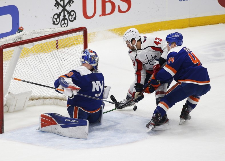 Apr 24, 2021; Uniondale, New York, USA; New York Islanders goaltender Ilya Sorokin (30) defends his net as center Jean-Gabriel Pageau (44) checks Washington Capitals right wing Tom Wilson (43) off the puck during the first at Nassau Veterans Memorial Coliseum. Mandatory Credit: Andy Marlin-USA TODAY Sports