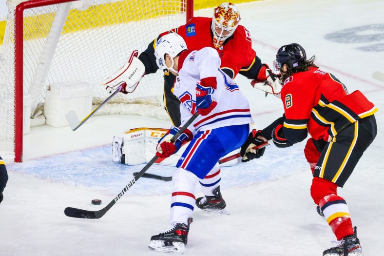 Apr 24, 2021; Calgary, Alberta, CAN; Montreal Canadiens center Nick Suzuki (14) scores a goal against Calgary Flames goaltender Jacob Markstrom (25) during the first period at Scotiabank Saddledome. Mandatory Credit: Sergei Belski-USA TODAY Sports