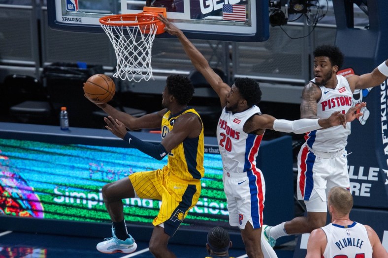 Apr 24, 2021; Indianapolis, Indiana, USA; Indiana Pacers guard Caris LeVert (22) shoots the ball while Detroit Pistons guard Josh Jackson (20) defends in the third quarter at Bankers Life Fieldhouse. Mandatory Credit: Trevor Ruszkowski-USA TODAY Sports