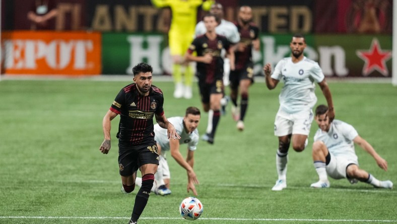 Apr 24, 2021; Atlanta, Georgia, USA; Atlanta United midfielder Marcelino Moreno (10) runs after the ball against the Chicago Fire during the first half at Mercedes-Benz Stadium. Mandatory Credit: Dale Zanine-USA TODAY Sports