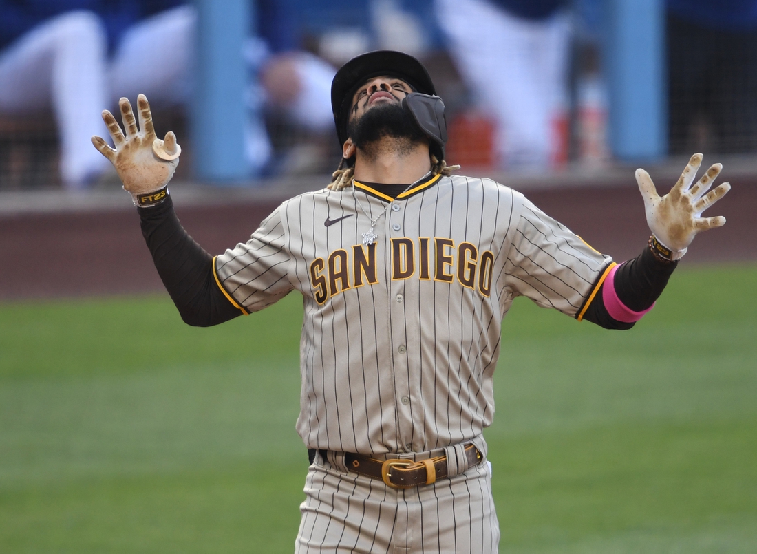 Apr 24, 2021; Los Angeles, California, USA;  San Diego Padres shortstop Fernando Tatis Jr. (23)crosses the plate after hitting a solo home run off the second pitch of the game from Los Angeles Dodgers starting pitcher Trevor Bauer (27) in the first inning at Dodger Stadium. Mandatory Credit: Jayne Kamin-Oncea-USA TODAY Sports