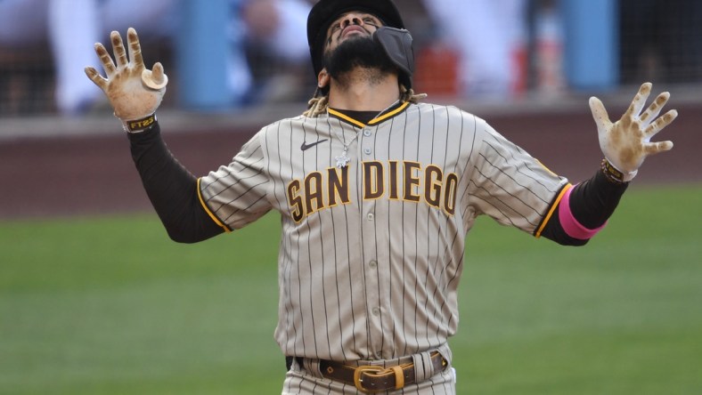 Apr 24, 2021; Los Angeles, California, USA;  San Diego Padres shortstop Fernando Tatis Jr. (23)crosses the plate after hitting a solo home run off the second pitch of the game from Los Angeles Dodgers starting pitcher Trevor Bauer (27) in the first inning at Dodger Stadium. Mandatory Credit: Jayne Kamin-Oncea-USA TODAY Sports