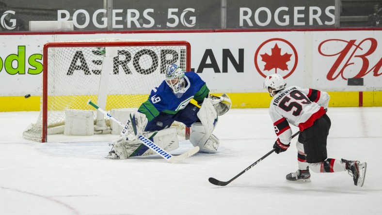 Apr 24, 2021; Vancouver, British Columbia, CAN; Vancouver Canucks goalie Braden Holtby (49) makes a save on a penalty shot attempt taken by Ottawa Senators forward Alex Formenton (59) in the second period at Rogers Arena. Canucks won 4-2.  Mandatory Credit: Bob Frid-USA TODAY Sports