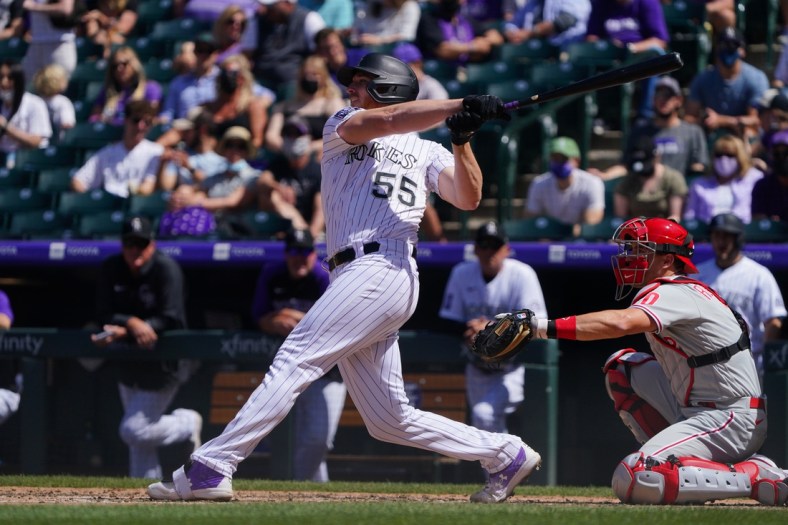 Apr 25, 2021; Denver, Colorado, USA; Colorado Rockies starting pitcher Jon Gray (55) hits a RBI single in the fourth inning against the Philadelphia Phillies Coors Field. Mandatory Credit: Ron Chenoy-USA TODAY Sports
