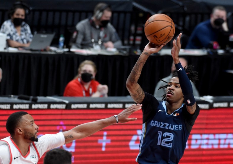 Apr 25, 2021; Portland, Oregon, USA; Memphis Grizzlies guard Ja Morant (12) shoot the ball on Portland Trail Blazers forward Norman Powell (24) during the first half of the game at Moda Center. Mandatory Credit: Steve Dykes-USA TODAY Sports
