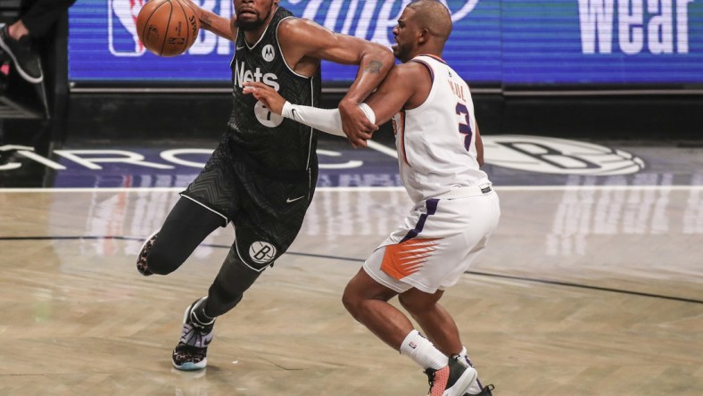 Brooklyn Nets forward Kevin Durant (7) drives past Phoenix Suns guard Chris Paul (3) in the third quarter at Barclays Center. Mandatory Credit: Wendell Cruz-USA TODAY Sports