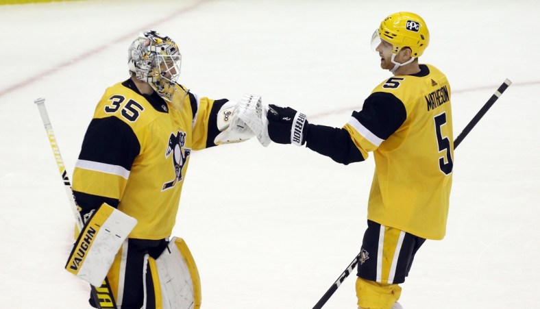 Apr 25, 2021; Pittsburgh, Pennsylvania, USA;  Pittsburgh Penguins defenseman Mike Matheson (5) congratulates Pittsburgh Penguins goaltender Tristan Jarry (35) on his shutout of the Boston Bruins at PPG Paints Arena. The Penguins shutout the Bruins 1-0. Mandatory Credit: Charles LeClaire-USA TODAY Sports