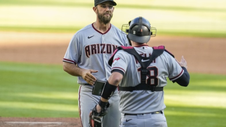 Apr 25, 2021; Cumberland, Georgia, USA; Arizona Diamondbacks starting pitcher Madison Bumgarner (40) reacts with teammates after pitching a seven inning no hit no run game against the Atlanta Braves in game two at Truist Park. Mandatory Credit: Dale Zanine-USA TODAY Sports