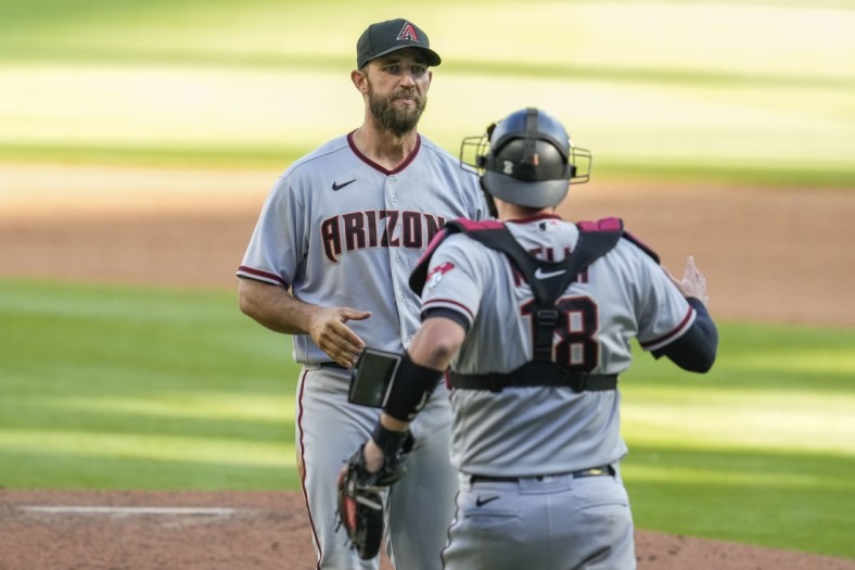 Apr 25, 2021; Cumberland, Georgia, USA; Arizona Diamondbacks starting pitcher Madison Bumgarner (40) reacts with teammates after pitching a seven inning no hit no run game against the Atlanta Braves in game two at Truist Park. Mandatory Credit: Dale Zanine-USA TODAY Sports
