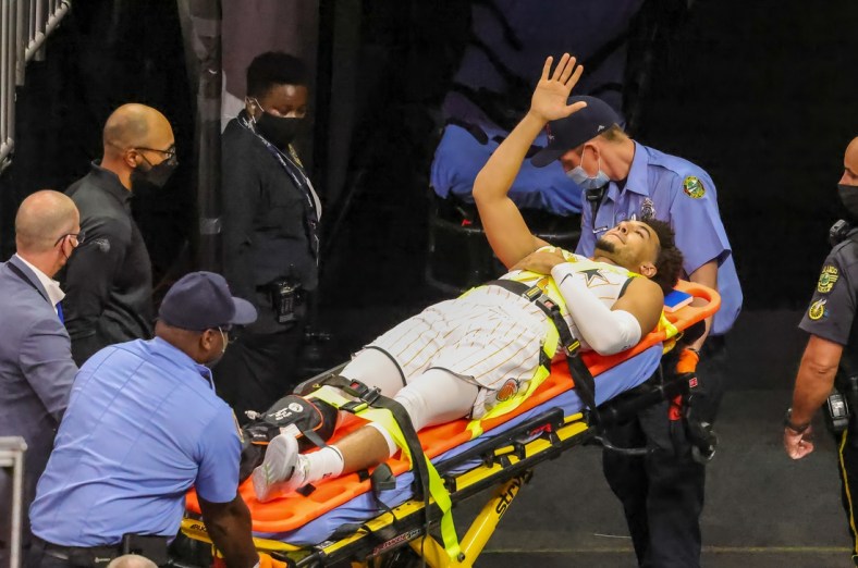 Apr 25, 2021; Orlando, Florida, USA; Orlando Magic guard Devin Cannady (30) waves to fans while being taken out on a stretcher after being injured against the Indiana Pacers during the first quarter at Amway Center. Mandatory Credit: Mike Watters-USA TODAY Sports