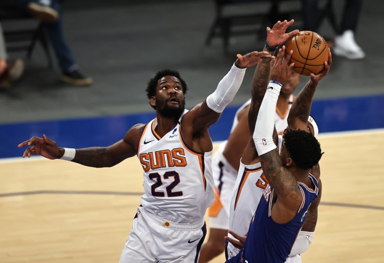 Apr 26, 2021; New York, New York, USA;  Elfrid Payton #6 of the New York Knicks heads for the net as Deandre Ayton #22 and Torrey Craig #12 of the Phoenix Suns defend in the first half at Madison Square Garden. Mandatory Credit:  Elsa/POOL PHOTOS-USA TODAY Sports