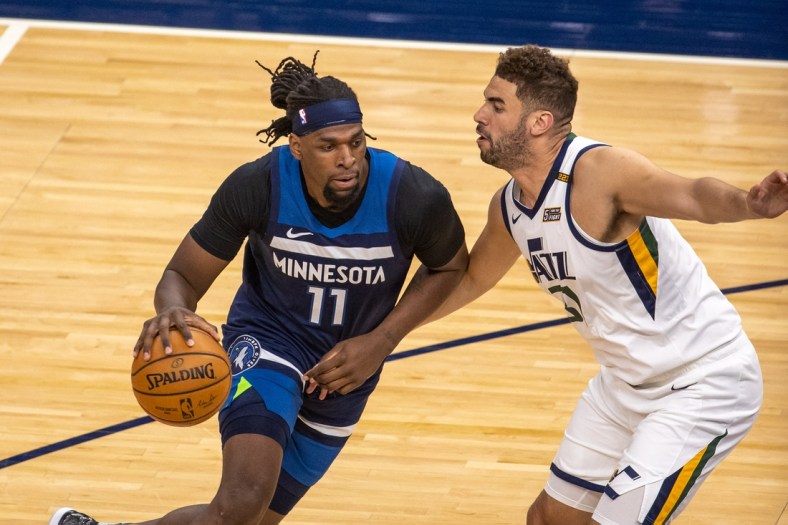 Apr 26, 2021; Minneapolis, Minnesota, USA; Minnesota Timberwolves center Naz Reid (11) drives to the basket as Utah Jazz forward Georges Niang (31) defends during the first half at Target Center. Mandatory Credit: Jesse Johnson-USA TODAY Sports
