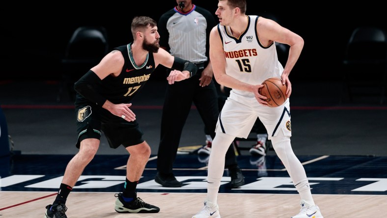 Apr 26, 2021; Denver, Colorado, USA; Denver Nuggets center Nikola Jokic (15) controls the ball as Memphis Grizzlies center Jonas Valanciunas (17) guards in the first quarter at Ball Arena. Mandatory Credit: Isaiah J. Downing-USA TODAY Sports