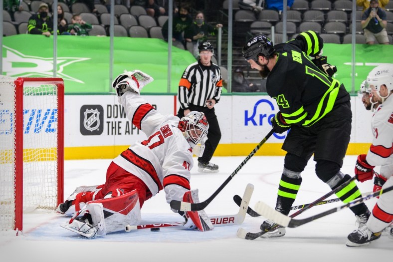 Apr 26, 2021; Dallas, Texas, USA; Dallas Stars left wing Jamie Benn (14) scores the game winning goal against Carolina Hurricanes goaltender James Reimer (47) during the overtime period at the American Airlines Center. Mandatory Credit: Jerome Miron-USA TODAY Sports