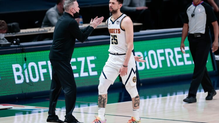 Apr 26, 2021; Denver, Colorado, USA; Denver Nuggets guard Austin Rivers (25) walks off the court during a timeout as head coach Michael Malone (L) reacts during the third quarter against the Memphis Grizzlies at Ball Arena. Mandatory Credit: Isaiah J. Downing-USA TODAY Sports