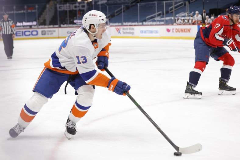 Apr 27, 2021; Washington, District of Columbia, USA; New York Islanders center Mathew Barzal (13) skates with the puck past Washington Capitals left wing Michael Raffl (17) in the first period at Capital One Arena. Mandatory Credit: Geoff Burke-USA TODAY Sports