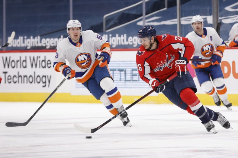 Apr 27, 2021; Washington, District of Columbia, USA; Washington Capitals center Nic Dowd (26) skates with the puck as New York Islanders center Casey Cizikas (53) defends in the first period at Capital One Arena. Mandatory Credit: Geoff Burke-USA TODAY Sports